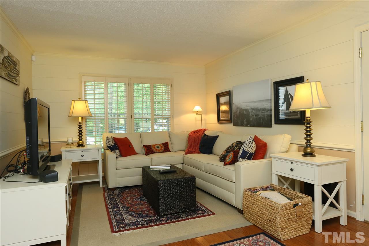 4505 Old Colony Road Raleigh, NC 27613 - Photo 24 of 30 a living room with furniture wooden floor and a flat screen tv
