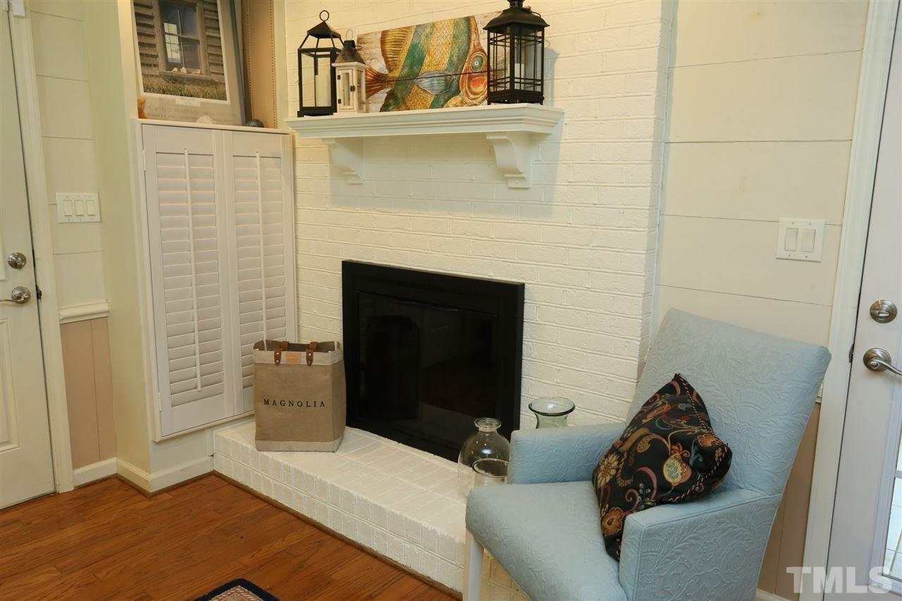 4505 Old Colony Road Raleigh, NC 27613 - Photo 25 of 30 a living room with furniture and a fireplace