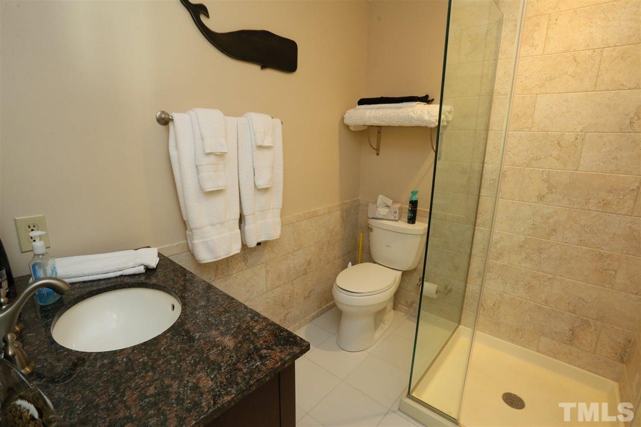 4505 Old Colony Road Raleigh, NC 27613 - Photo 28 of 30 a bathroom with a granite countertop sink toilet and shower