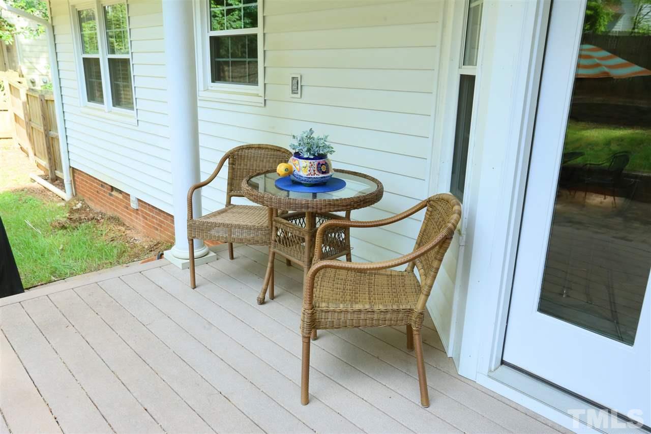 4505 Old Colony Road Raleigh, NC 27613 - Photo 7 of 30 a porch with a table and chairs