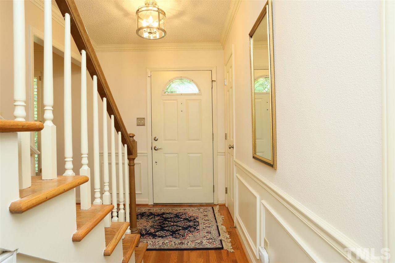 4505 Old Colony Road Raleigh, NC 27613 - Photo 8 of 30 a view of hallway with stairs and wooden floor