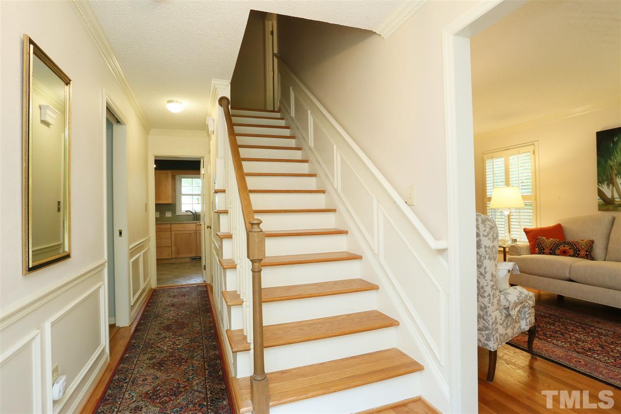 4505 Old Colony Road Raleigh, NC 27613 - Photo 9 of 30 a view of a hallway with wooden floor and staircase