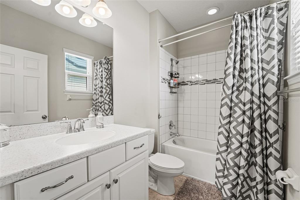 8903 Arabella Lane Seminole, FL 33777 - Photo 30 of 47 a bathroom with a sink toilet a mirror and shower