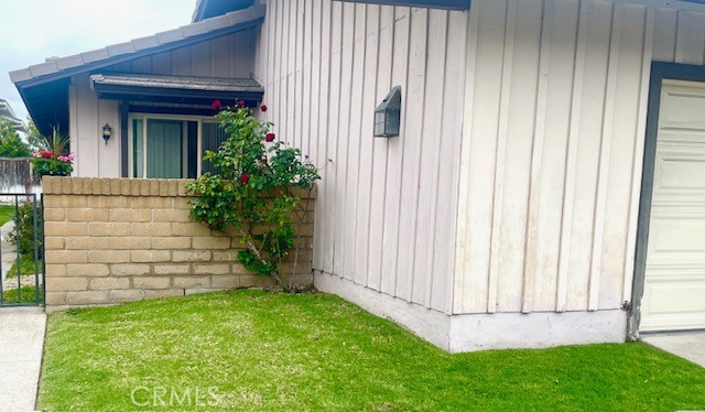 an entrance view of a house with a garden