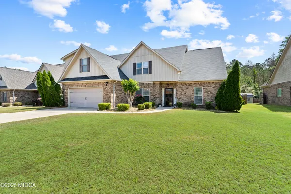 a front view of house with yard and green space
