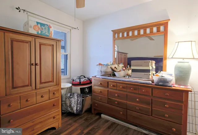 a living room with furniture a dining table and chairs with wooden floor