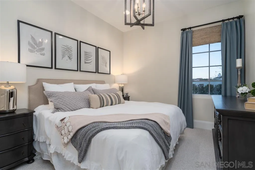 8920 Via Rancho Cielo Rancho Santa Fe, CA 92067 - Photo 15 of 25 a bedroom with a large bed and a window