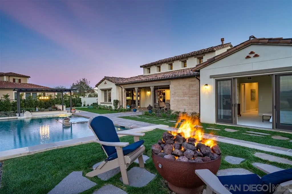 8920 Via Rancho Cielo Rancho Santa Fe, CA 92067 - Photo 19 of 25 a front view of a house with swimming pool garden and patio