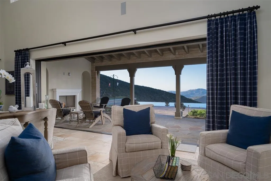 8920 Via Rancho Cielo Rancho Santa Fe, CA 92067 - Photo 4 of 25 a living room with furniture and a large window