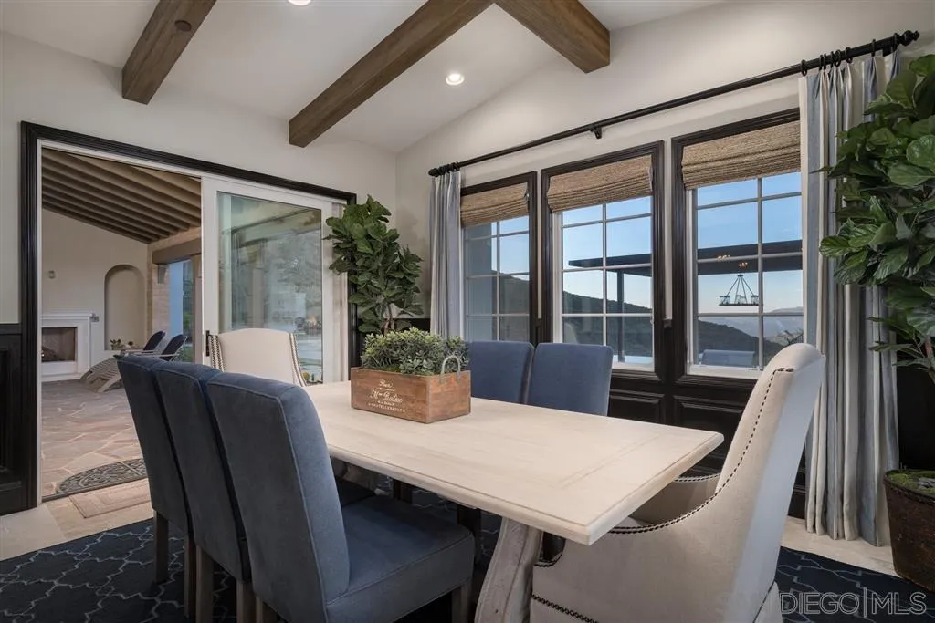 8920 Via Rancho Cielo Rancho Santa Fe, CA 92067 - Photo 8 of 25 a view of a dining room with furniture window and wooden floor
