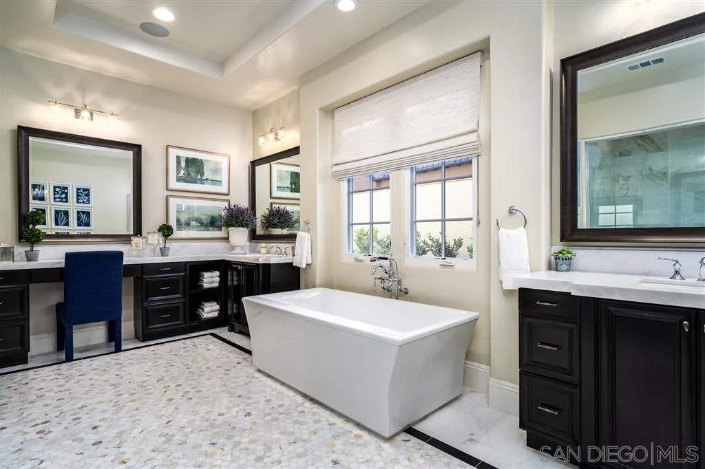 8920 Via Rancho Cielo Rancho Santa Fe, CA 92067 - Photo 10 of 25 a large bathroom with a sink double vanity and a mirror