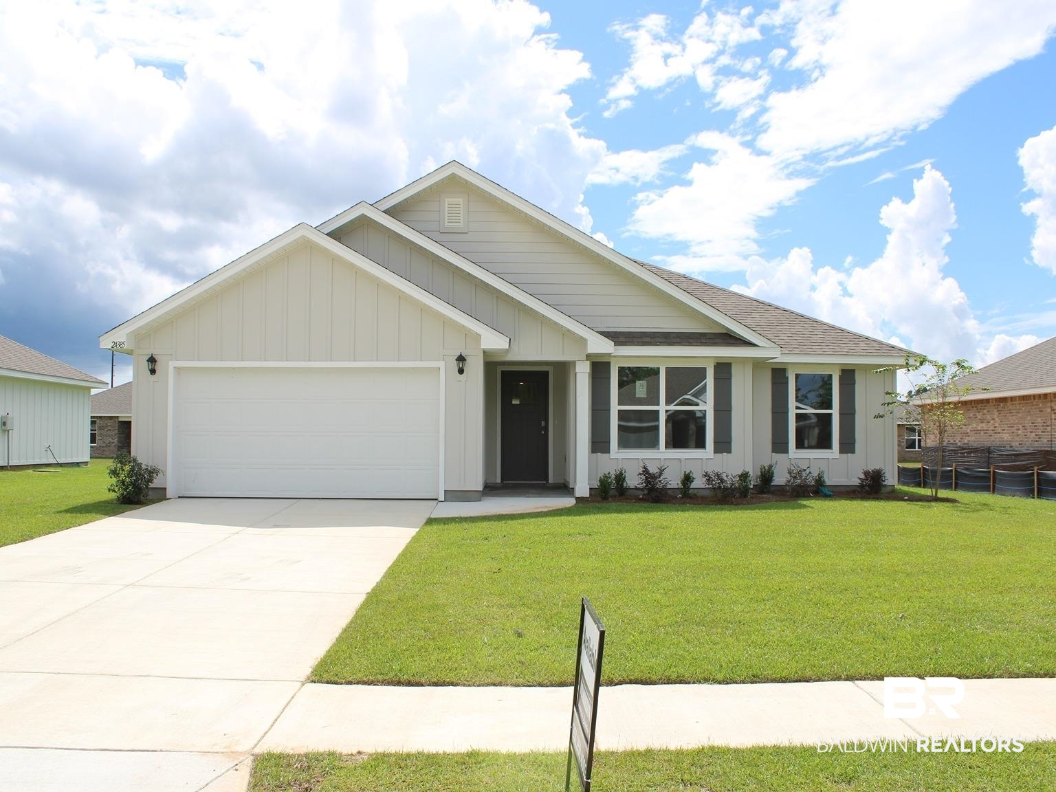 24385 Ringneck Loop Elberta, AL 36530 - Photo 1 of 33 View of front of property featuring a garage and a front lawn