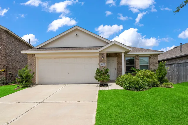 a front view of house with a garden