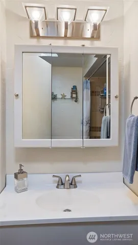 a kitchen with a sink cabinets and wooden floor