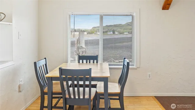 a view of a dining room with furniture and wooden floor