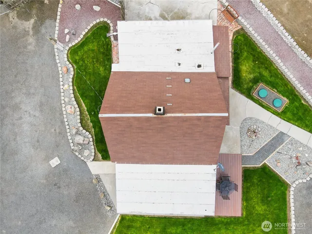 an aerial view of a house with a yard and plants