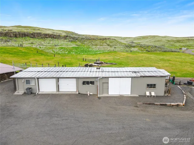 a aerial view of a house with a yard and ocean view