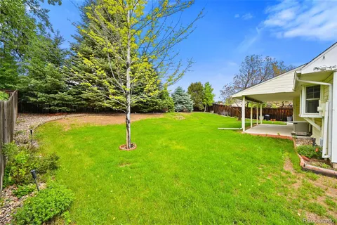 a view of a house with a yard and sitting area