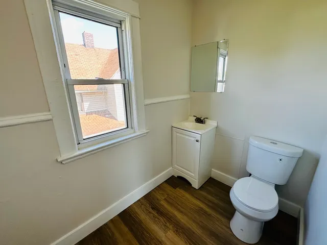 a bathroom with a toilet sink and a window