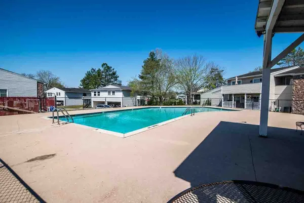 a view of a room with wooden floor and a bathroom
