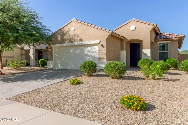 a front view of a house with a yard and a garage