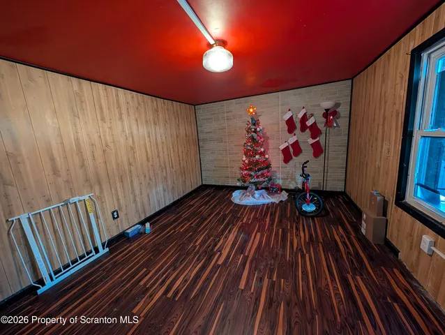 a view of a room with wooden floor and staircase
