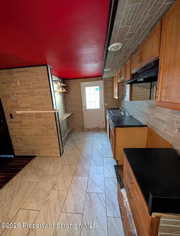 a hallway with a car parked in the yard