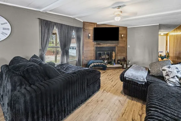 a living room with furniture fireplace and a flat screen tv