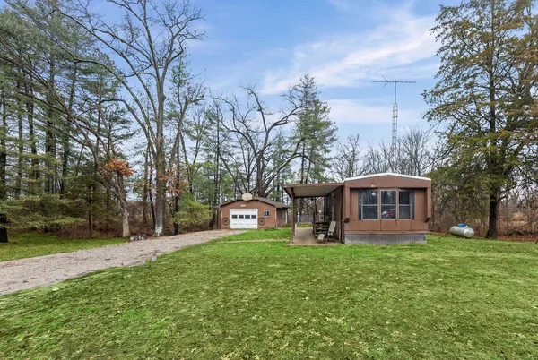 a view of a house with a yard and sitting area