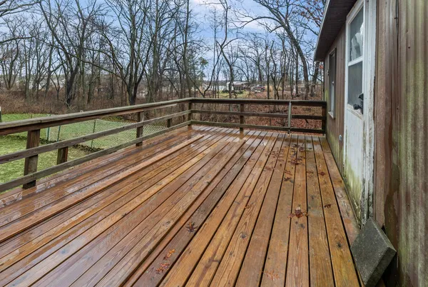 a view of balcony with wooden floor and fence