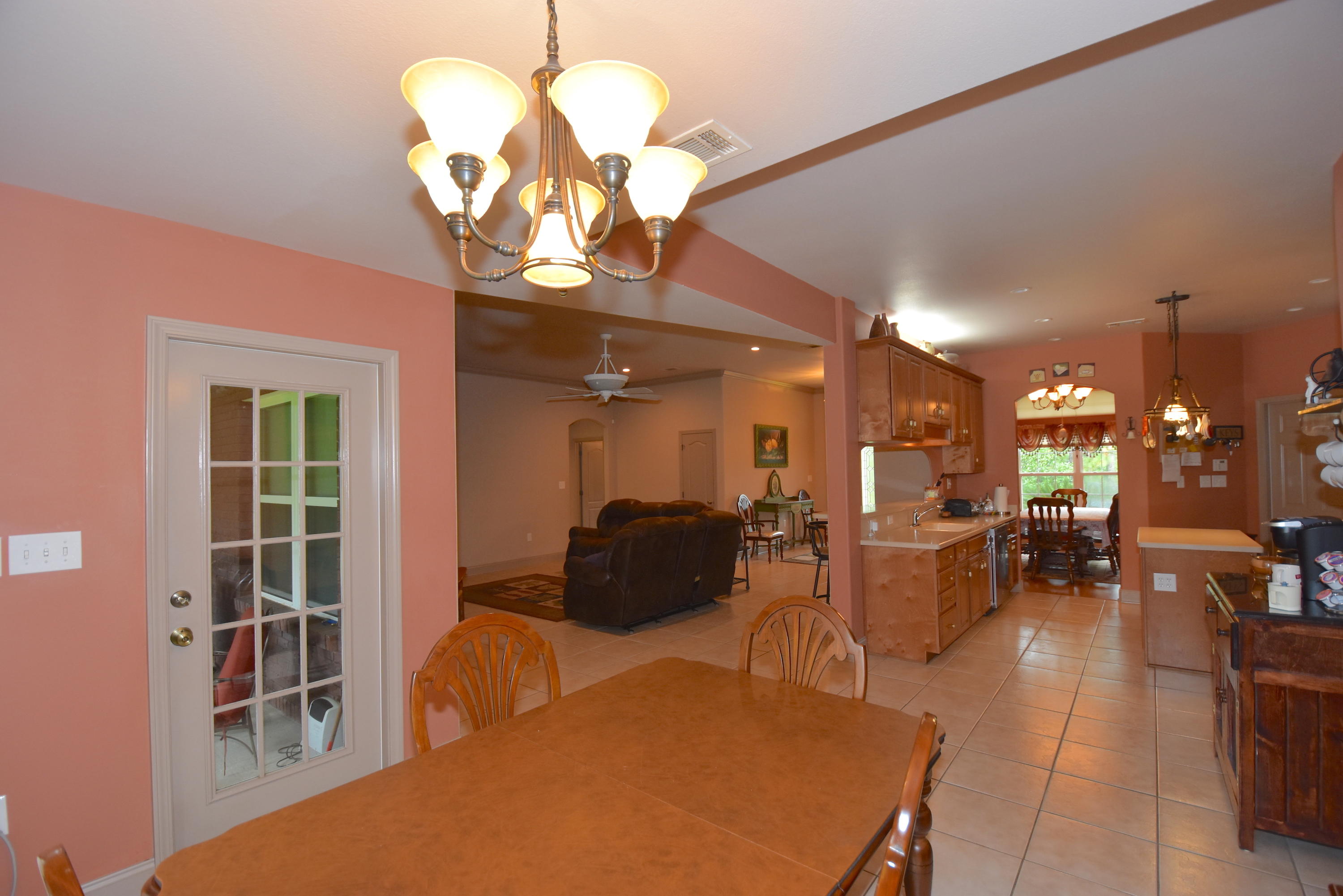 6000 Gagnon Road Crestview, FL 32539 - Photo 11 of 51 a living room with furniture a chandelier and a dining table