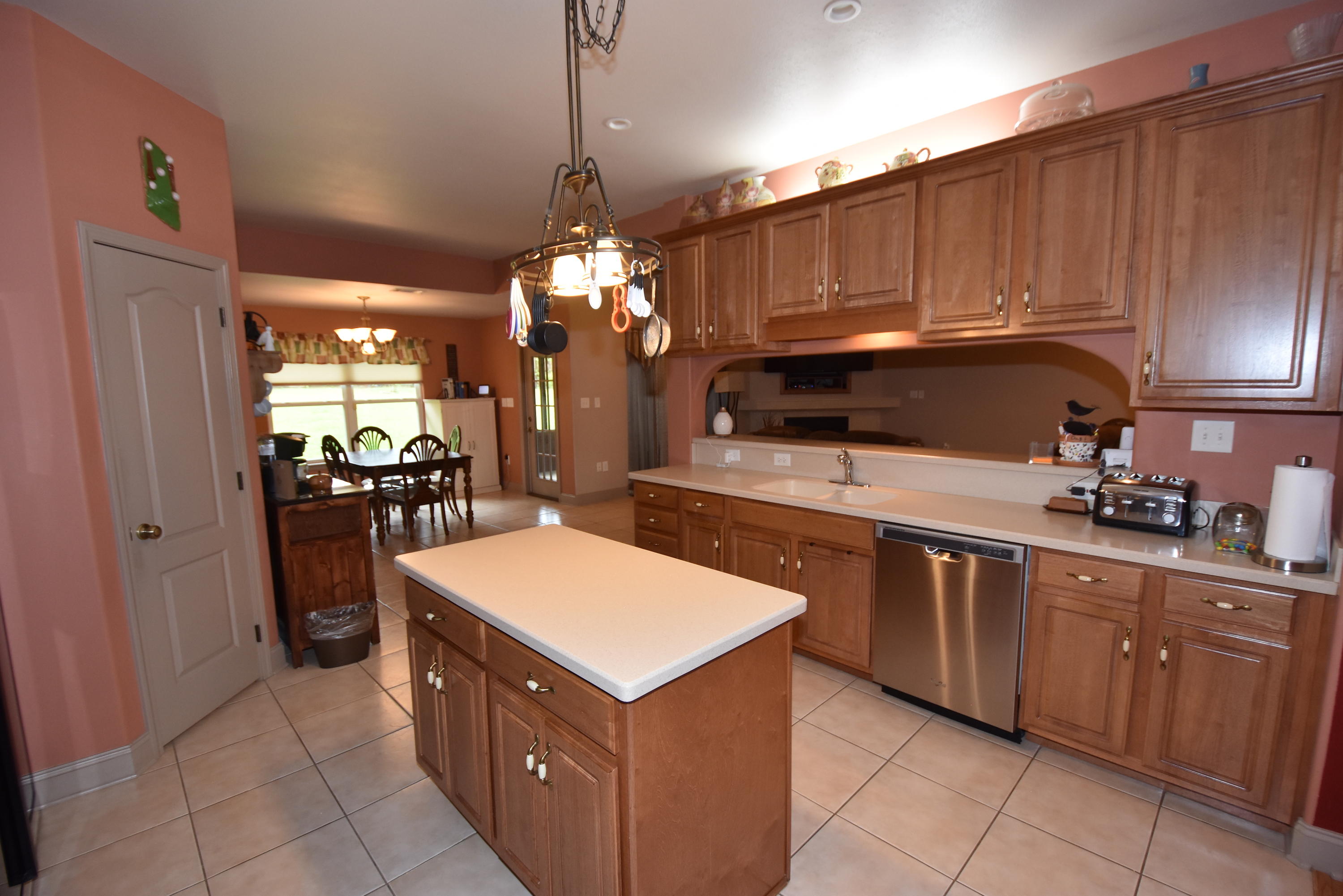 6000 Gagnon Road Crestview, FL 32539 - Photo 15 of 51 a kitchen with stainless steel appliances a sink dishwasher stove and refrigerator with wooden cabinets