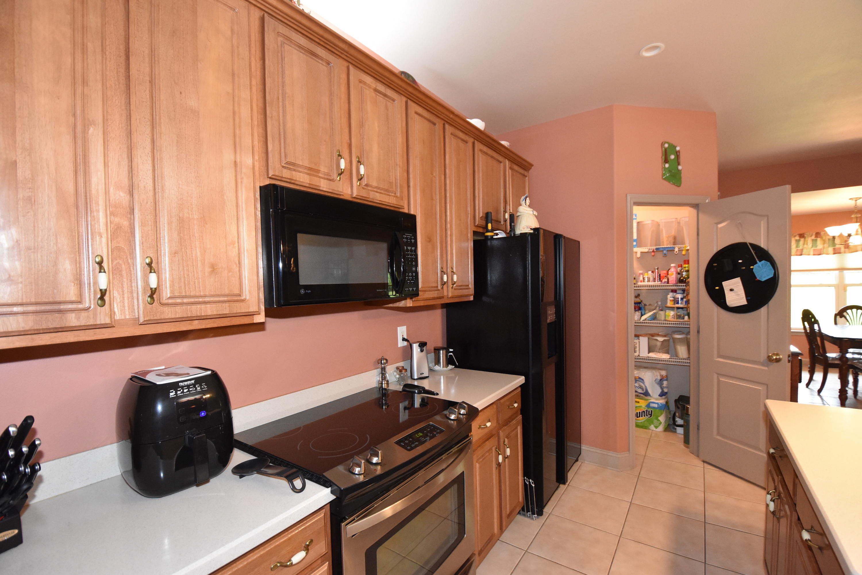 6000 Gagnon Road Crestview, FL 32539 - Photo 16 of 51 a kitchen with wooden cabinets and a stove top oven