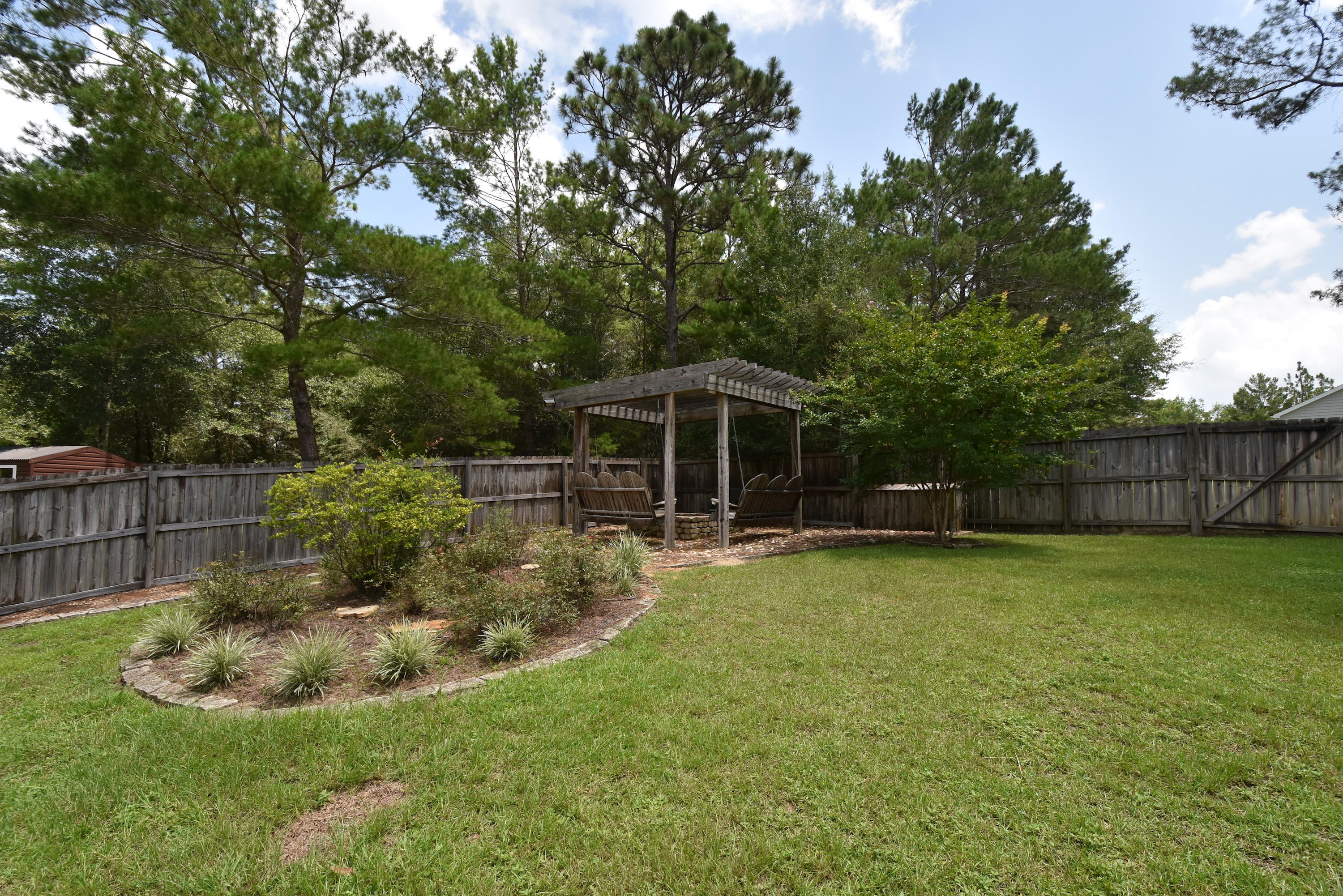 6000 Gagnon Road Crestview, FL 32539 - Photo 2 of 51 a view of a backyard with table and chairs potted plants and large tree