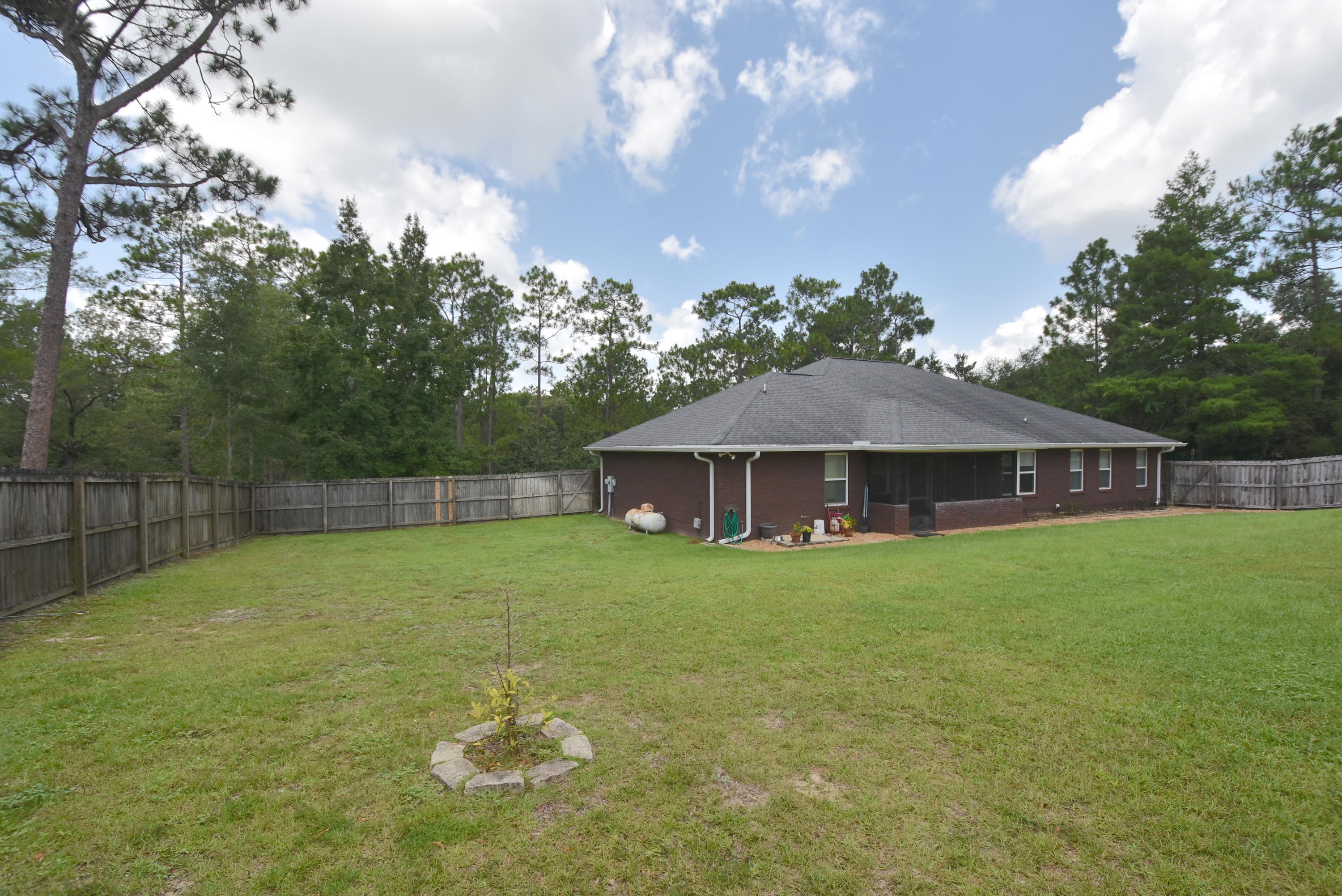 6000 Gagnon Road Crestview, FL 32539 - Photo 43 of 51 a backyard of a house with lots of green space