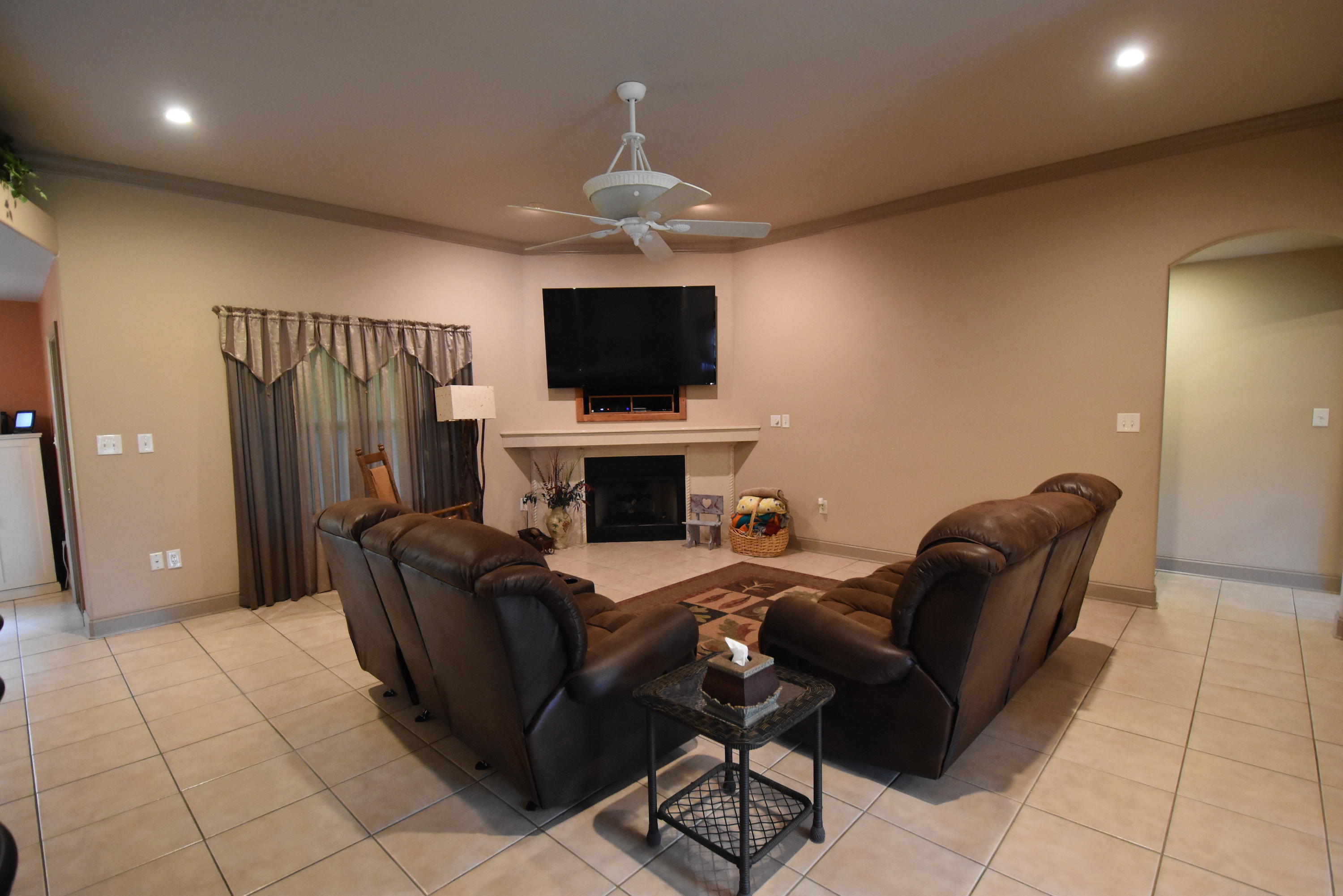 6000 Gagnon Road Crestview, FL 32539 - Photo 6 of 51 a living room with furniture a flat screen tv and a fireplace