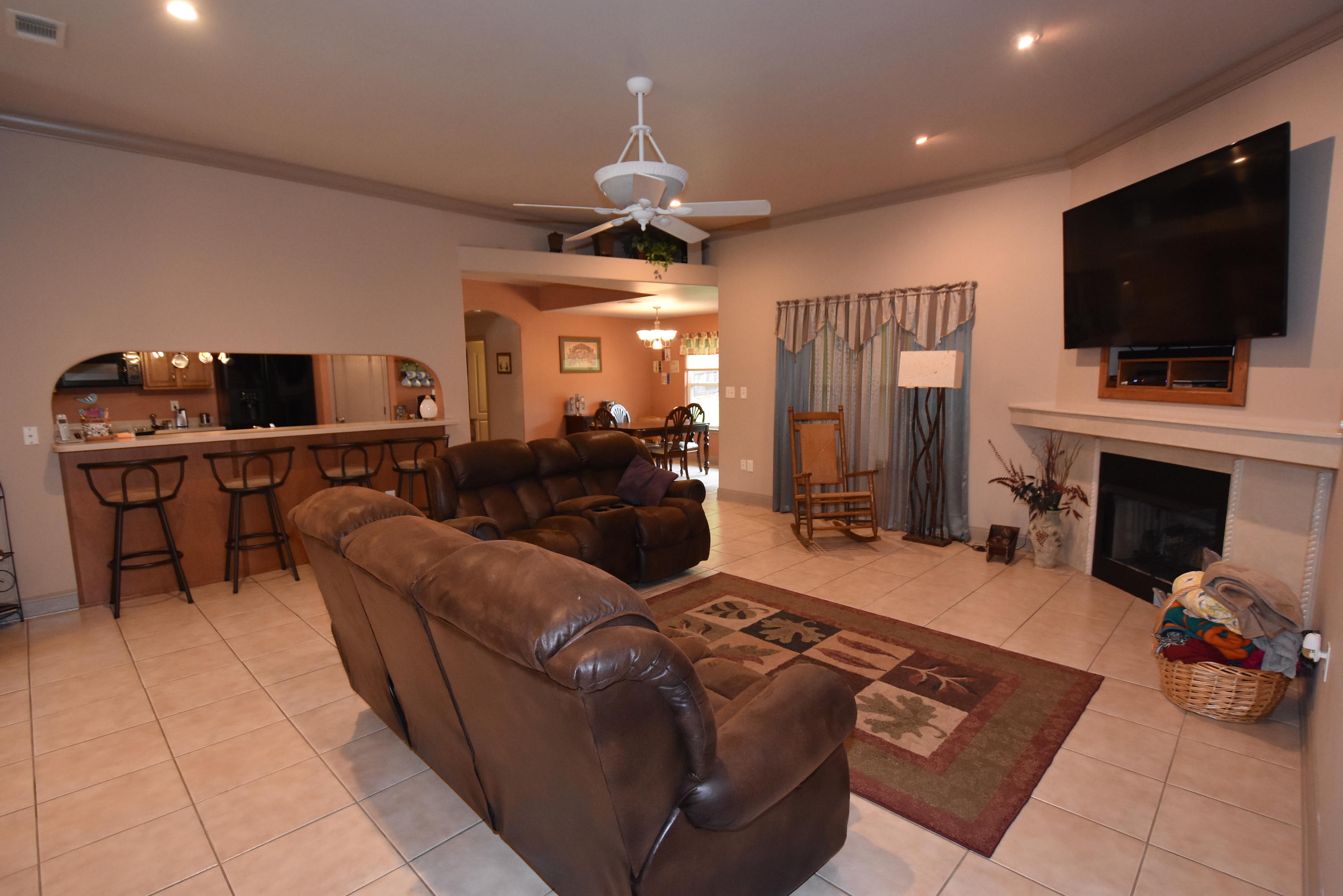 6000 Gagnon Road Crestview, FL 32539 - Photo 8 of 51 a living room with furniture a flat screen tv and a fireplace