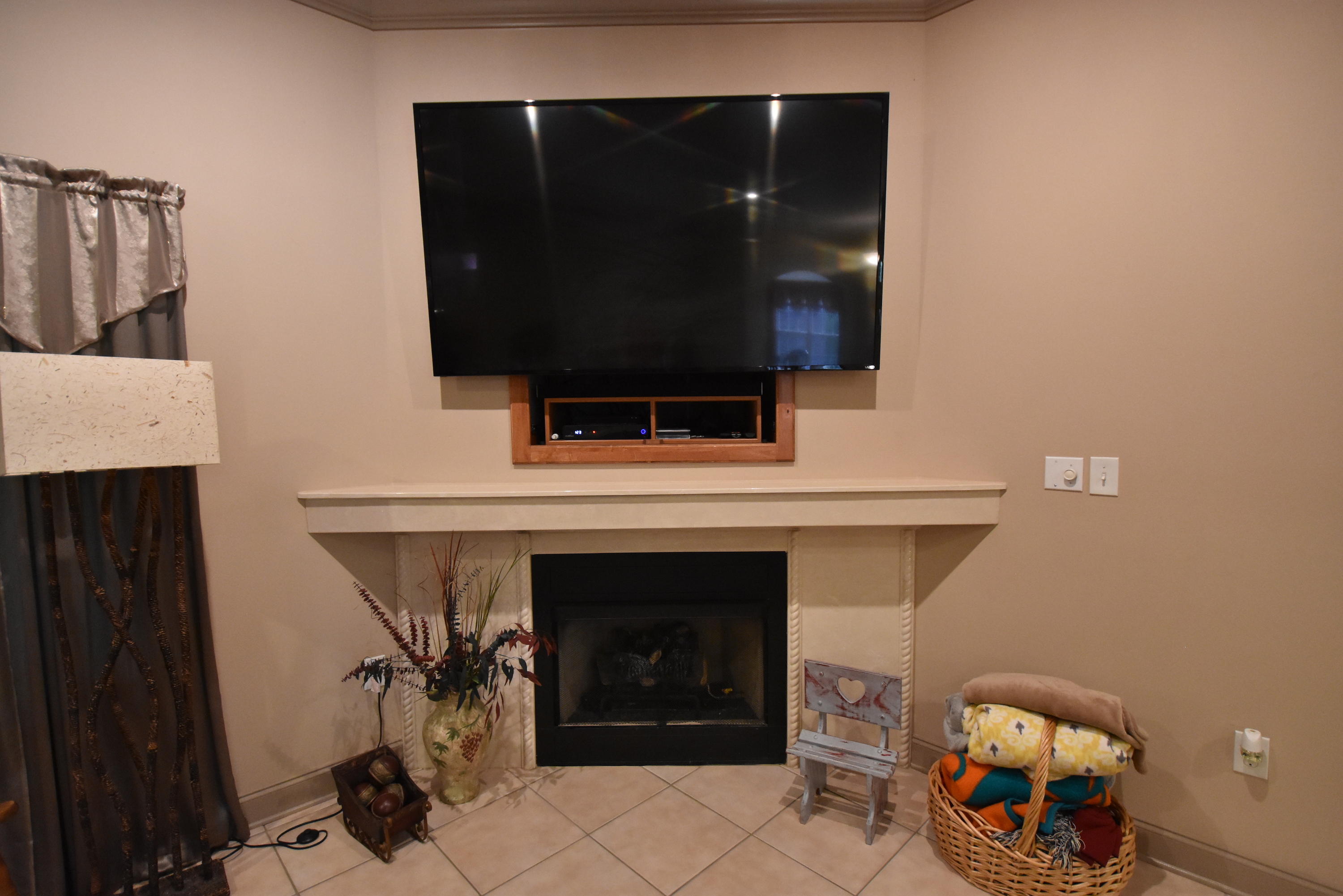 6000 Gagnon Road Crestview, FL 32539 - Photo 9 of 51 a living room with a fireplace and a flat screen tv