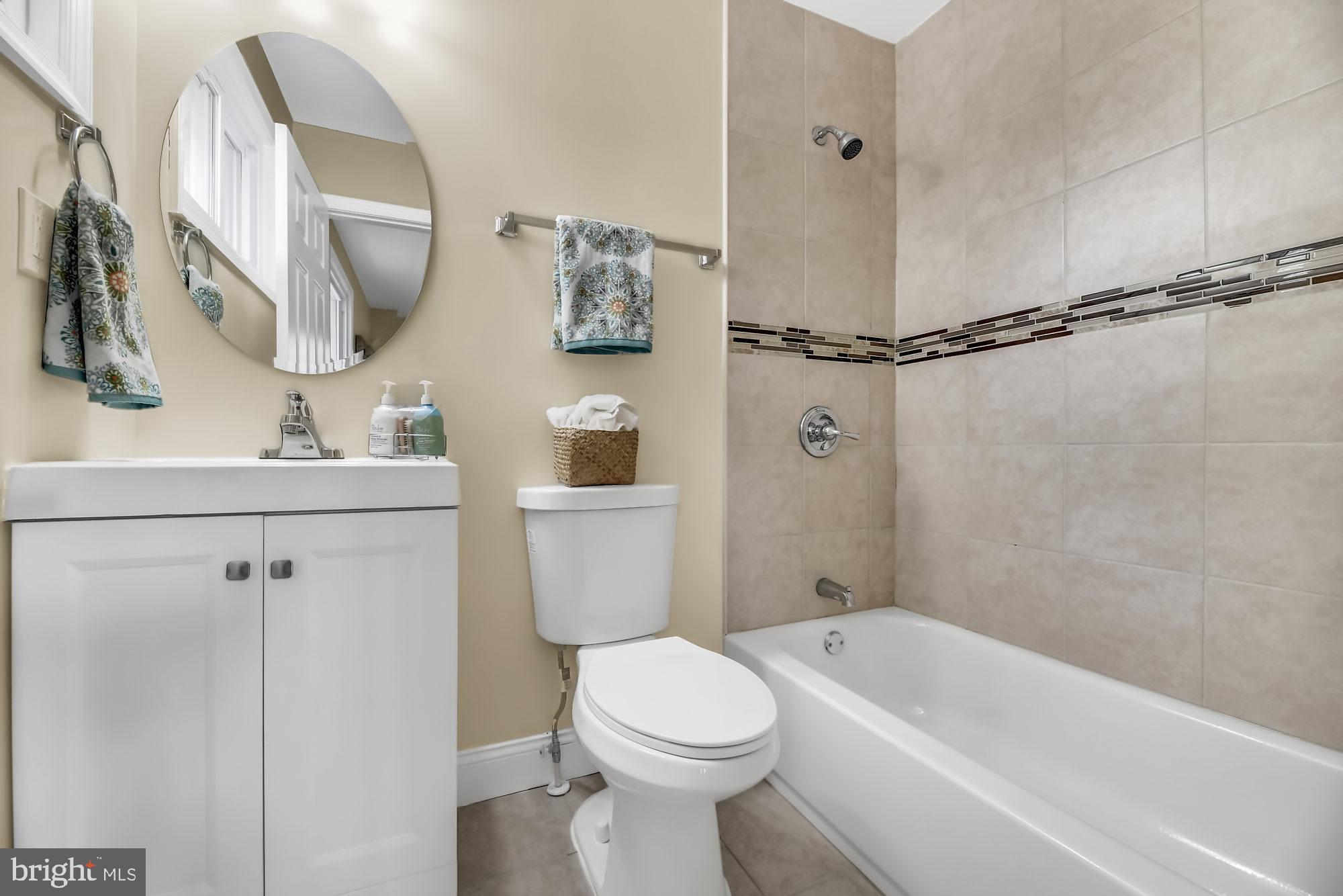 3713 Cassen Road Randallstown, MD 21133 - Photo 16 of 27 a bathroom with a toilet sink and shower