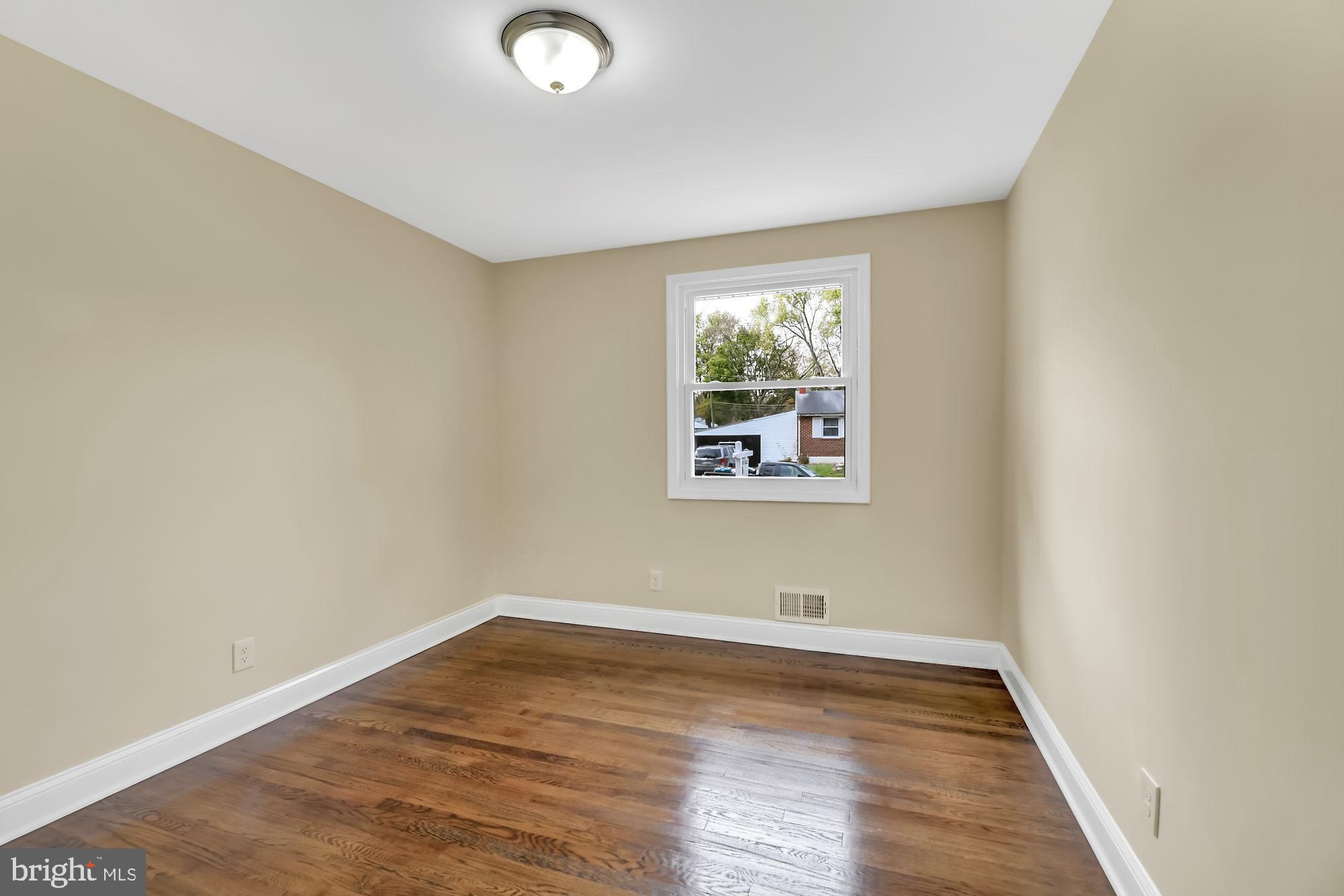 3713 Cassen Road Randallstown, MD 21133 - Photo 17 of 27 an empty room with wooden floor and window