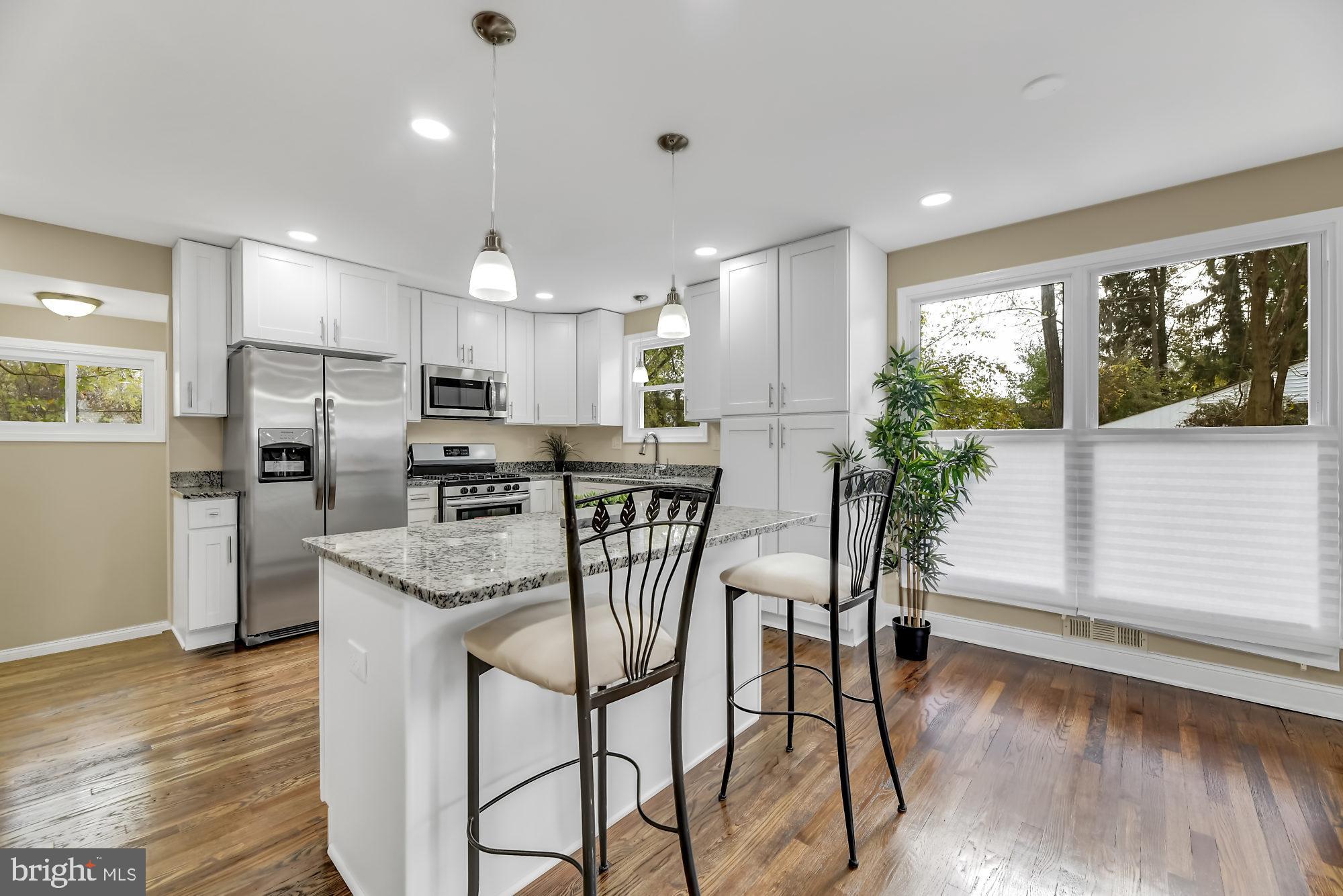 3713 Cassen Road Randallstown, MD 21133 - Photo 6 of 27 a kitchen with granite countertop stainless steel appliances a refrigerator and microwave