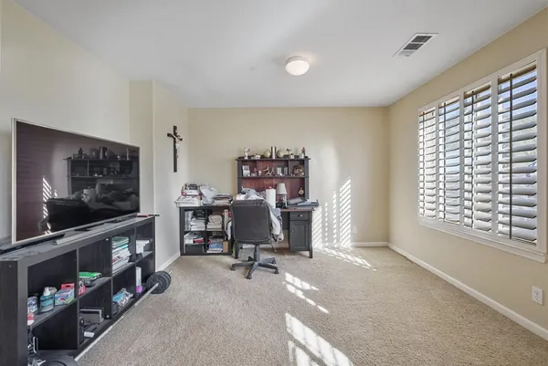 a view of a livingroom with furniture and a window