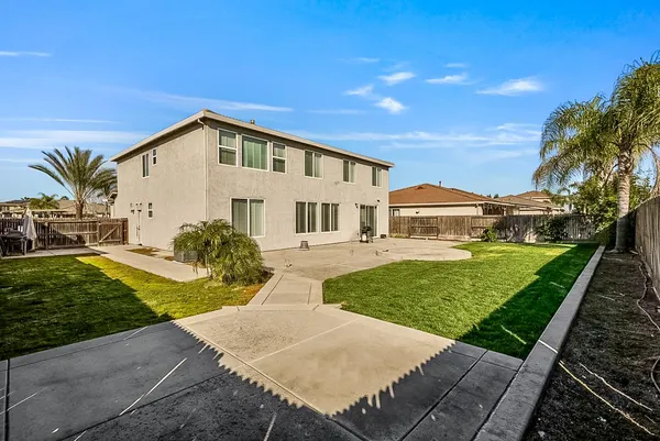 a view of a livingroom with wooden floor and a chandelier