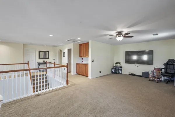 a view of a livingroom with furniture and a flat screen tv