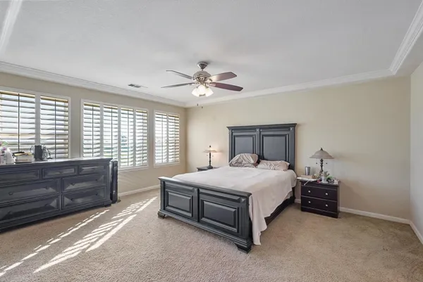 a bedroom with a bed dresser and a window