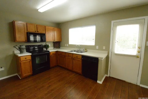 a kitchen with a stove a sink and a microwave