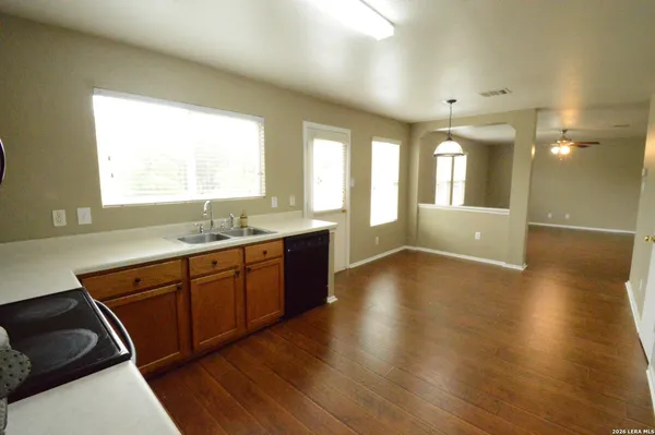 a spacious bathroom with a granite countertop sink and a large mirror