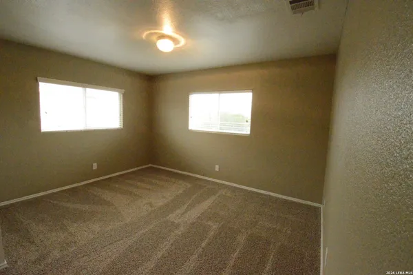 an empty room with a empty space and windows