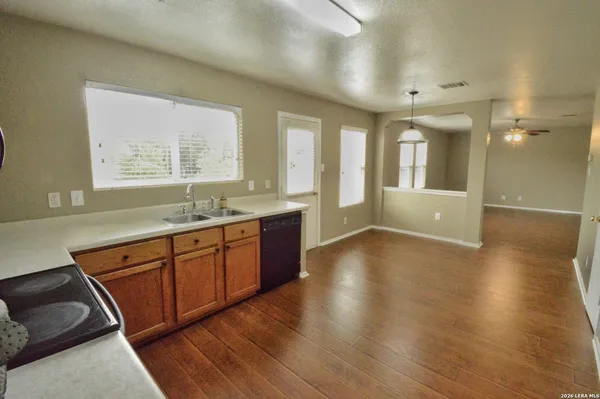 a spacious bathroom with a granite countertop sink and a large mirror