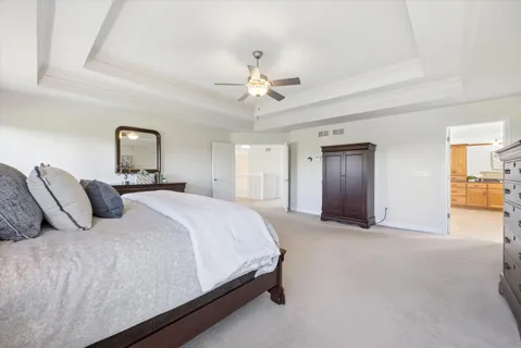 a spacious bedroom with a bed and a chandelier